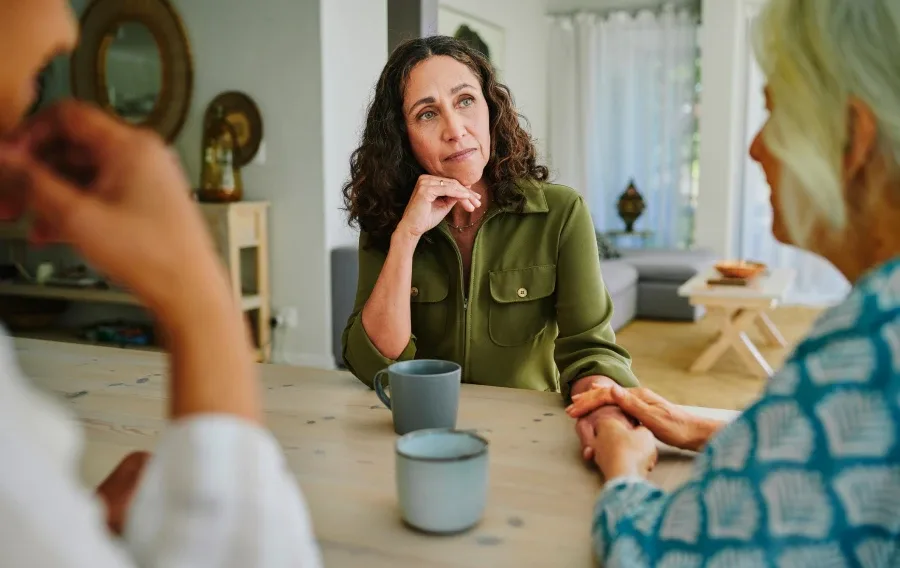 A woman listening to friends over coffee