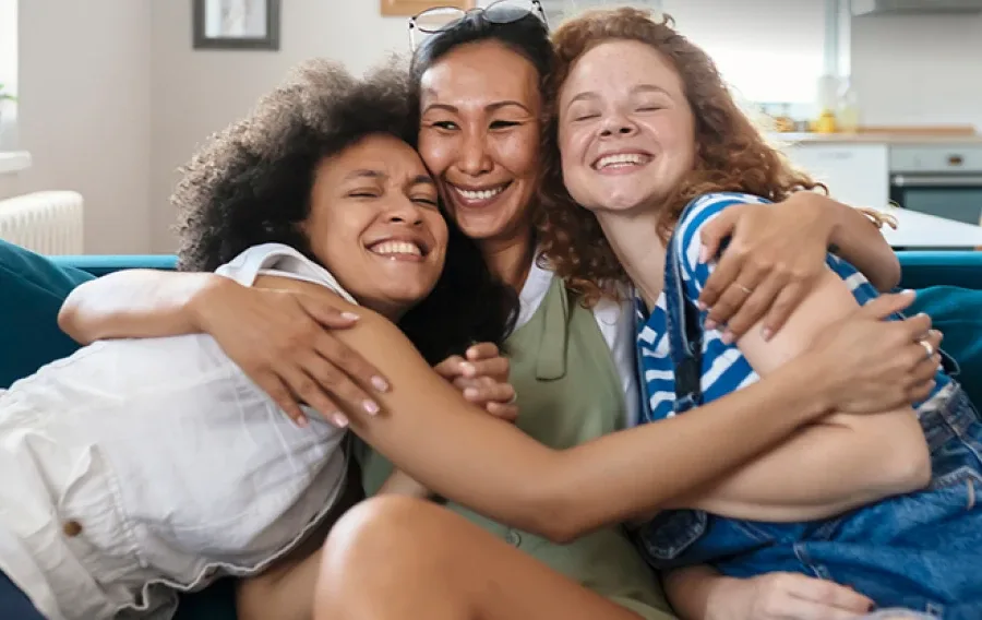Three friends hugging