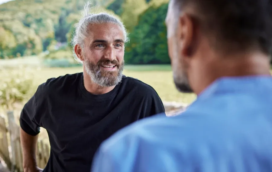 A man speaking with a friend