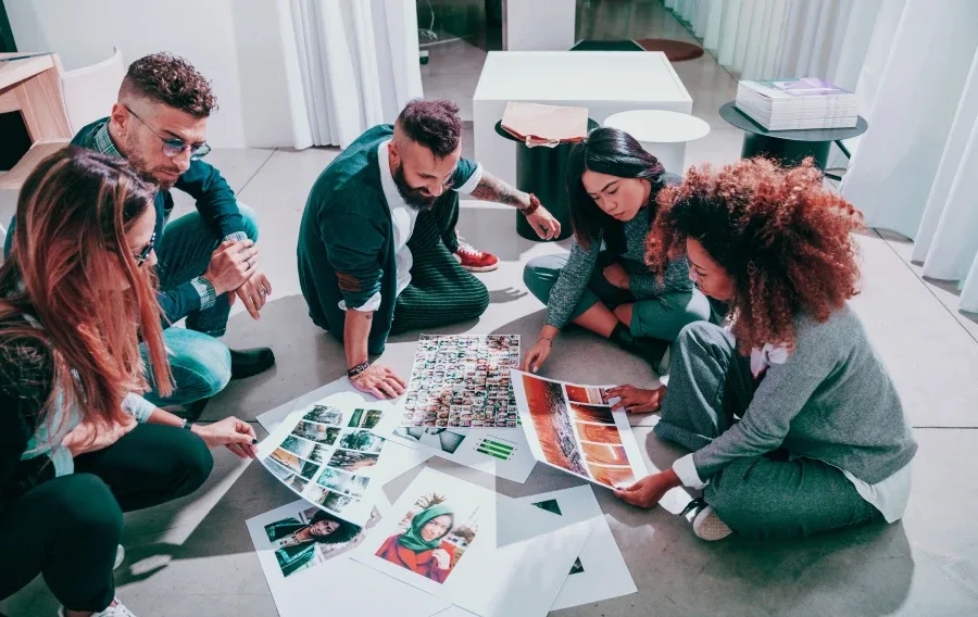 A group of people looking at photos