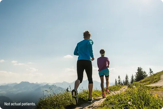 A young couple jogging in mountains
